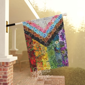 a colorful quilt hanging on a clothes line