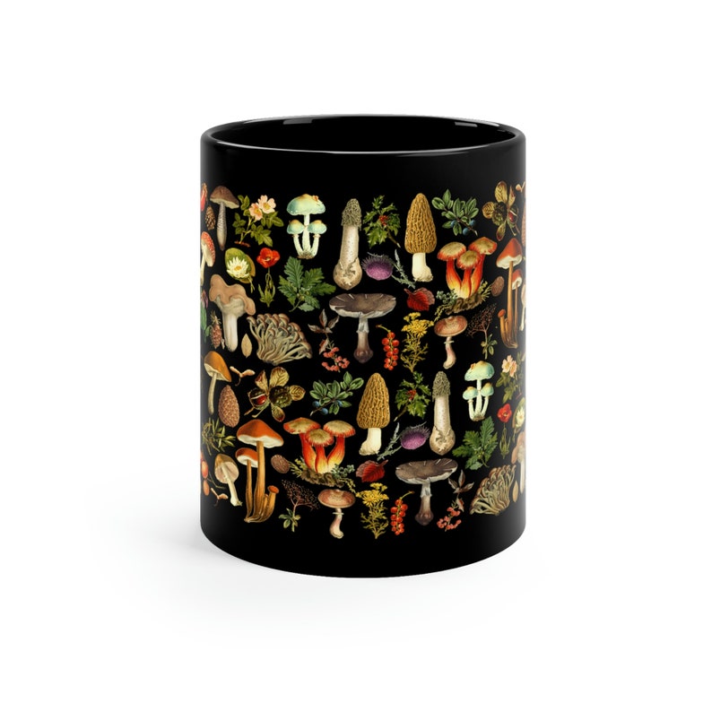 May include: Black ceramic mug with a colorful mushroom pattern. The mug is covered in a variety of mushrooms in different colors and shapes.