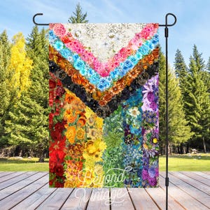 a multicolored quilt is hanging on a stand