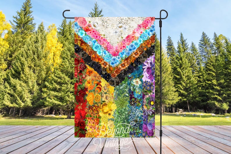 a multicolored quilt is hanging on a stand