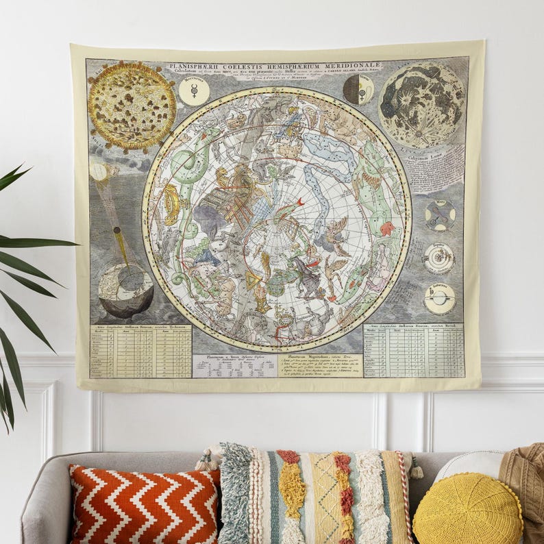 a couch with pillows and a tapestry hanging on the wall