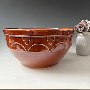 May include: A set of three ceramic mugs with a speckled, matte finish. The mugs are in shades of cream, light gray, and dark gray. Each mug has a simple, minimalist design and a rounded handle. The mugs are likely for coffee or tea.