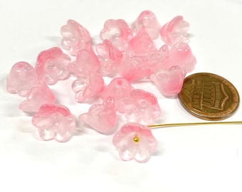 May include: A collection of pink glass flower beads. The beads are translucent and have a delicate, feminine look. They are perfect for adding a touch of elegance to jewelry or crafts.