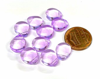 May include: Ten light purple glass beads with a slightly iridescent finish. The beads are oval shaped and have a flat back. The beads are approximately the size of a UK penny.