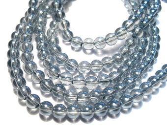 May include: A strand of light blue glass beads. The beads are round and have a clear, translucent appearance.