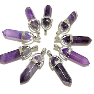 May include: Eight amethyst crystal point pendants with silver-tone metal settings. The pendants are arranged in a circle on a white background.