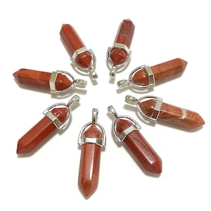 May include: Eight red jasper stone pendants with silver-toned metal settings. Each pendant features a pointed, faceted stone and a loop for attaching a chain.
