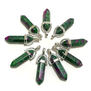 May include: Ten green and pink gemstone pendants with silver settings. The pendants are shaped like points and are arranged in a circle.