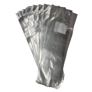 May include: A stack of clear plastic bags with a small white patch on one side. The bags are all folded and stacked on top of each other.