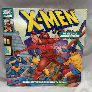 May include: A comic book cover featuring the X-Men characters, with the title "X-Men: To Stop a Juggernaut". The cover features a red and blue Juggernaut character, a yellow and blue Wolverine character, and a blue and yellow Cyclops character. The cover also includes the text "Based on the Blockbuster TV Series!"