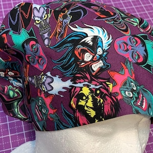 May include: A purple scrub cap featuring a repeating pattern of cartoon villains in various colors. The cap is made of fabric and is designed to cover the head. The cartoon characters have exaggerated features.