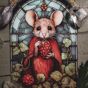 May include: A stained glass style illustration of a mouse wearing a red cloak and holding a large red berry. The mouse is surrounded by green and brown leaves.