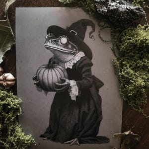May include: A monochrome illustration of a frog in a witch's hat and dress, holding a pumpkin. The frog's outfit includes a lace collar. The image has a vintage aesthetic, perfect for Halloween.