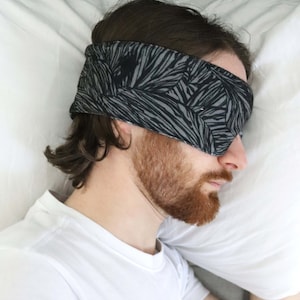 guy sleeping on his side with an eye mask