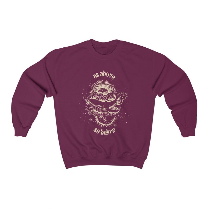 May include: Burgundy sweatshirt with a graphic of a whale swimming in clouds with the text "as above so below" in a vintage font.