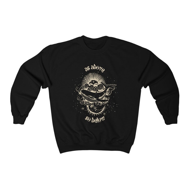 May include: Black sweatshirt with a white graphic of a whale swimming through the clouds with the sun and moon above and below it. The text "as above so below" is printed above the whale.