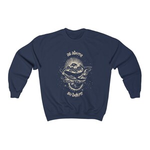 May include: Navy blue sweatshirt with a graphic of a whale swimming through clouds and stars. The text "as above so below" is printed below the whale.