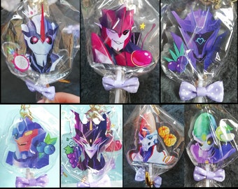 May include: Ten colorful lollipop charms featuring cartoon characters with a purple bow on each lollipop stick. The characters are from the Transformers franchise.  Lollipop Charms for $14 (free shipping).