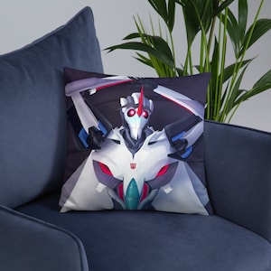 May include: A white and blue robot with red eyes and a red horn on its head. The robot is in a fighting pose with its arms raised. The background is dark blue.