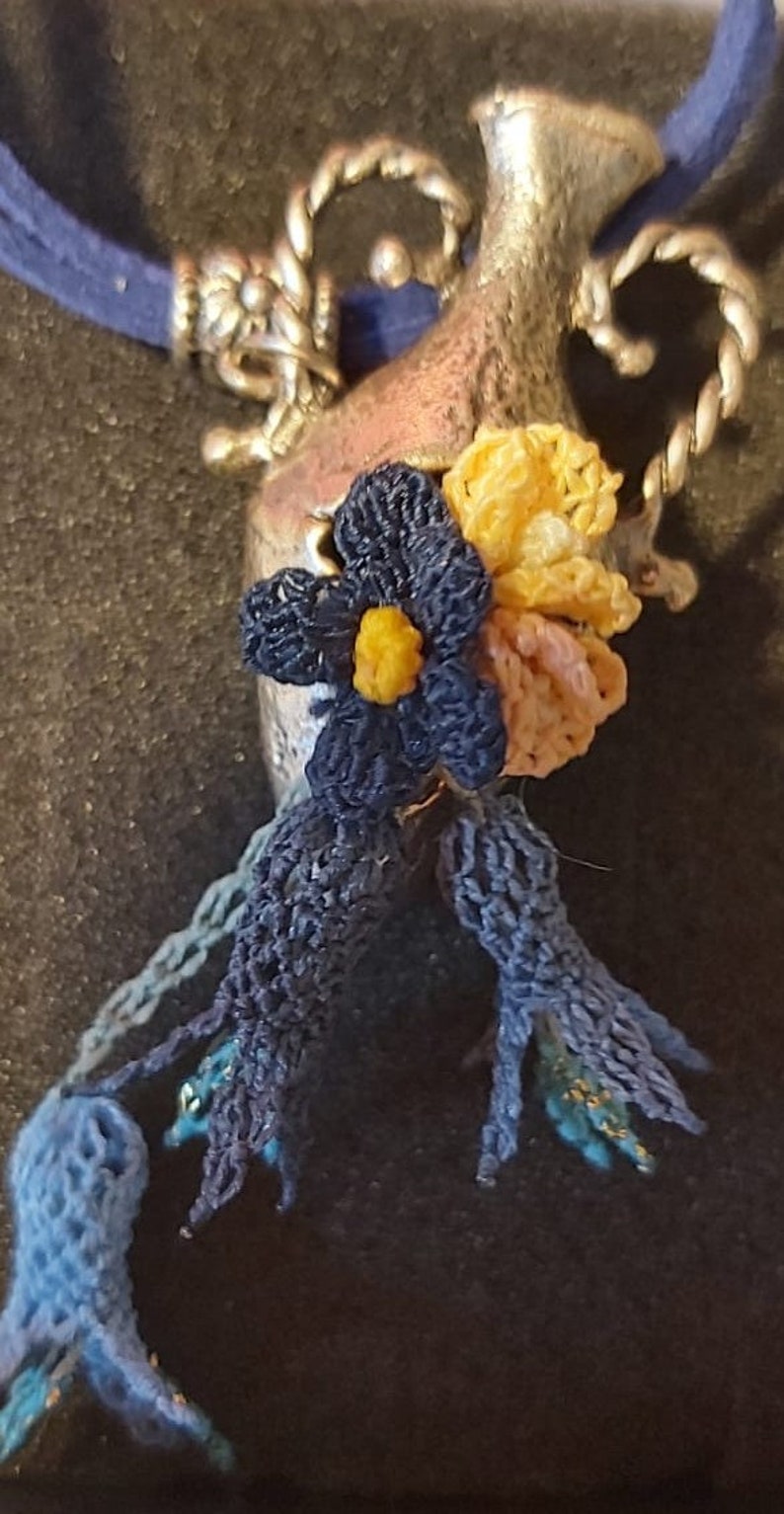 Handmade needle lace necklace on metal Special design.