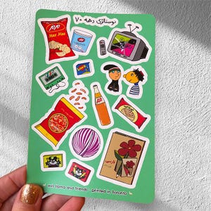 one sticker sheet in hand, showing nostalgic persian elements from the 90s such as kolah ghermezi va pesar khaleh, plastic ball, and maz maz chips