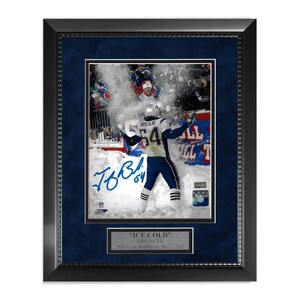 May include: Framed photo of a football player in a Patriots uniform, number 54, celebrating in the snow. The photo is signed and includes a plaque that reads "ICE COLD" Bruschi.