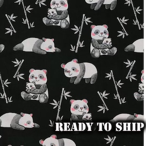May include: Black fabric with a repeating pattern of pandas and bamboo stalks. The pandas are in various poses, some holding baby pandas. The pandas are white and gray with pink accents. The text "READY TO SHIP" is visible.