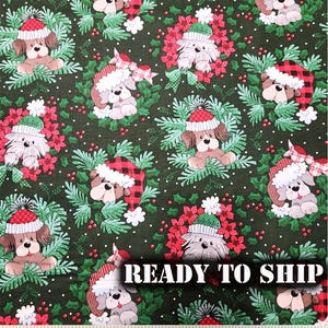 May include: Green fabric with a repeating pattern of dogs wearing Santa hats and wreaths. The dogs are brown, white, and black with red and white accents. The fabric has a white polka dot pattern and a green holly leaf pattern.