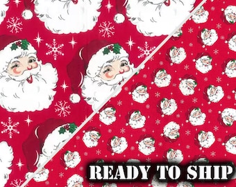 May include: Red fabric with a repeating pattern of Santa Claus faces. The Santa Claus faces are white with red hats and white beards. The background is red with white snowflakes and stars.