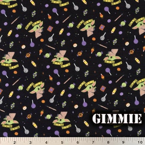 May include: Black fabric with a repeating pattern of a green alien character with the text "GIMMIE" above it. The pattern also includes candy, lollipops, and other small objects.