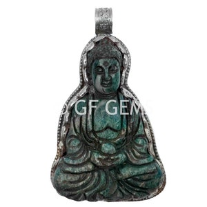 May include: A green jade Buddha pendant with a silver bail. The Buddha is sitting in a meditative pose with hands in the lap.