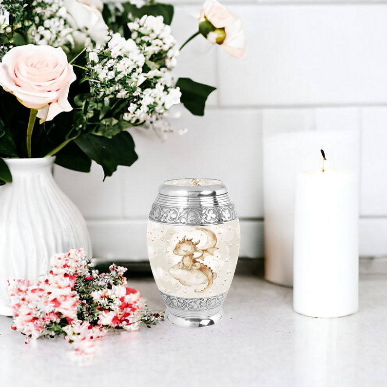 Keepsake baby dragon urn elegantly displayed with flowers, offering a beautiful and unique way to remember a loved one. Ideal for small portions of ashes.