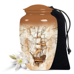 May include: A brown ceramic urn with a vintage world map design featuring a sailing ship. The urn comes with a black velvet drawstring bag.