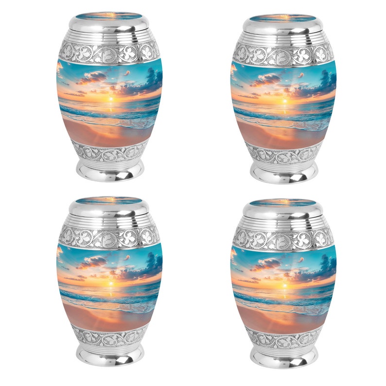 May include: Four silver urns with a beach sunset scene printed on the front. The urns have an ornate design around the top and bottom.