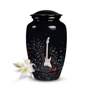 May include: Black cremation urn with a colorful electric guitar and musical notes design.