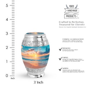May include: A silver aluminum urn with a beach sunset scene. The urn is 3 inches tall and is handcrafted. The urn is made with a decorative pattern and is 100% handmade.