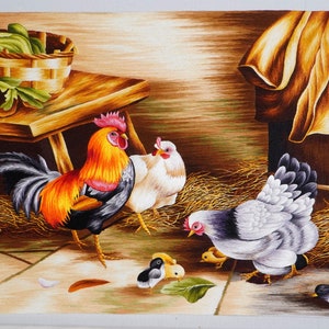 May include: A colorful embroidered painting depicting a rooster, two hens, and three chicks. The rooster is black, orange, and yellow with a red comb. The hens are white and gray. The chicks are yellow and black. The painting is set against a brown background with a wooden table and a brown cloth.