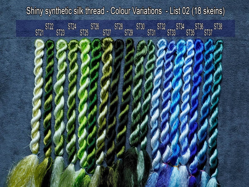 May include: A collection of 18 skeins of shiny synthetic silk thread in shades of green, blue, and white. The skeins are labeled with numbers from ST21 to ST38.