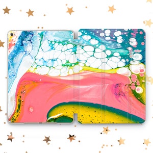 May include: A colorful abstract design with pink, yellow, blue, and green swirls and white bubbles. The design is printed on a tablet case.