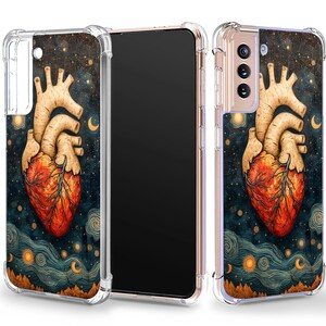 May include: A clear phone case with a colorful illustration of a stylized anatomical heart against a dark blue background with stars and moons. The case is designed for a smartphone with a camera bump.