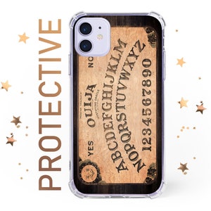May include: A clear phone case with a wood-grain background and a vintage-style Ouija board design. The board features the letters A-Z, numbers 0-9, and the words "YES", "NO", and "GOODBYE".