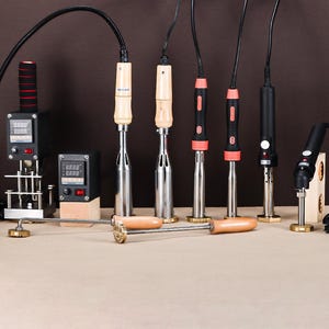 May include: A white ceramic mug with a black handle and the text "But First, Coffee" in a bold, black font. The mug is set against a neutral background, highlighting its simple design.