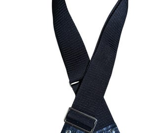 May include: Black adjustable bag strap with silver-tone metal hardware. The strap features a textured, woven design and faux leather accents at the ends. Includes two swivel clasps for easy attachment to a bag.