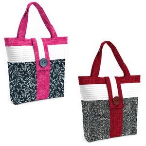 May include: Two tote bags with different fabric patterns. One bag is red, white, and black with a floral pattern. The other bag is pink, white, and black with a floral pattern. Both bags have a button closure.
