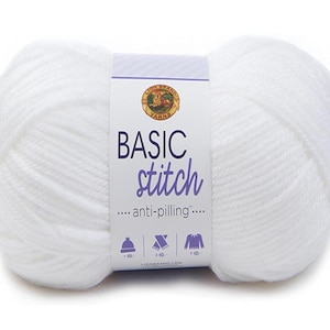 May include: A white yarn ball with a label that reads "BASIC stitch" and "anti-pilling". The label also features a logo and icons of a hat, scarf, and sweater. This yarn is suitable for knitting and crocheting projects.