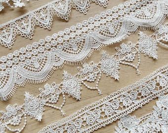 Various widths of white lace border with flowers