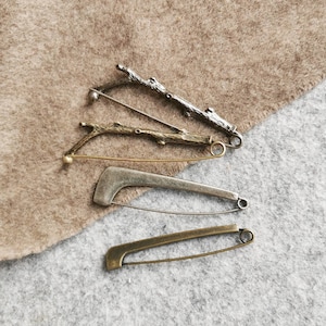 Decorative safety pin as an accessory and closure for scarves and ponchos