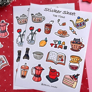 May include: A sticker sheet with a tea time theme. The sheet features illustrations of teapots, teacups, tea leaves, lemons, books, and a cat. The text "Tea Time" is written in a whimsical font.