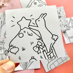 May include: A black and white line drawing of a rabbit placing a star on top of a Christmas tree. The rabbit is standing on a ladder and the tree is decorated with baubles and a bow.