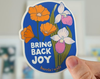 May include: A blue and white sticker with a floral design and the text "Bring Back Joy" with the artist's name "Harris | Waltz" at the bottom.